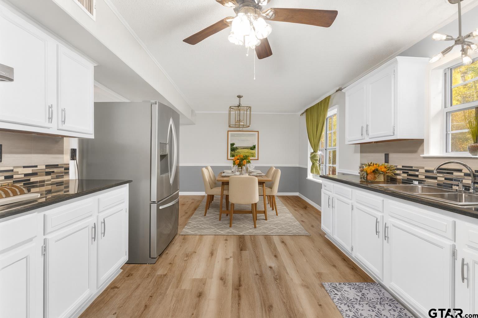 109 King Lyle Road Scroggins, TX 75480 - Photo 10 of 46 a living room with stainless steel appliances granite countertop furniture a fireplace a chandelier fan and a window