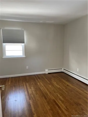 a view of a room with wooden floor and window