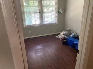 a room with wooden floor and a window