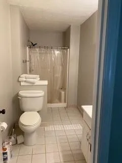a bathroom with a toilet and a shower