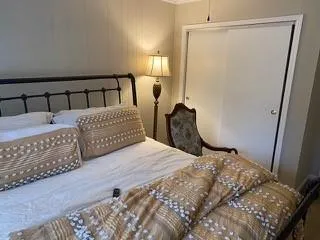 a bedroom with a bed and a mirror