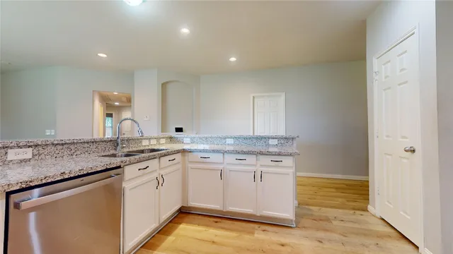 a kitchen with a sink stove and cabinets