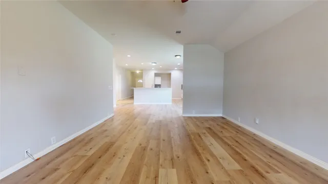 a view of a room with wooden floor and a window