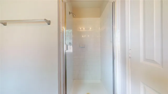 a bathroom with a glass shower door