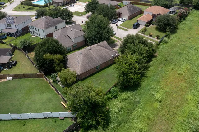 an aerial view of multiple houses with yard