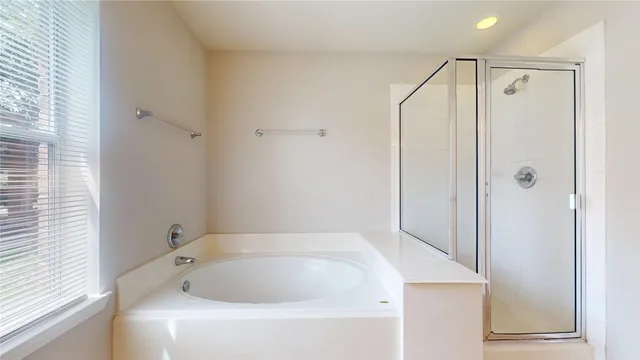 a bathroom with a tub a sink and a shower