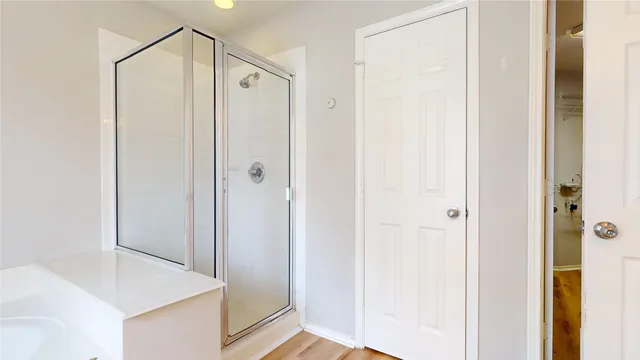 a bathroom with a shower and a glass door