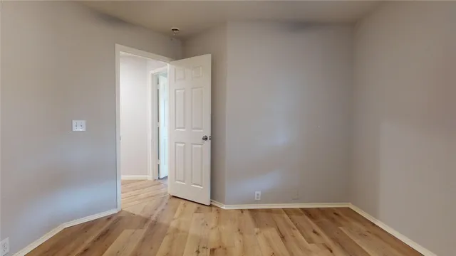 a view of a room with wooden floor