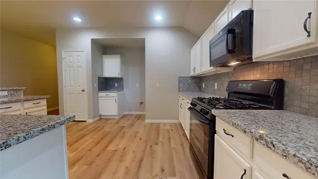 a kitchen with a stove and a sink