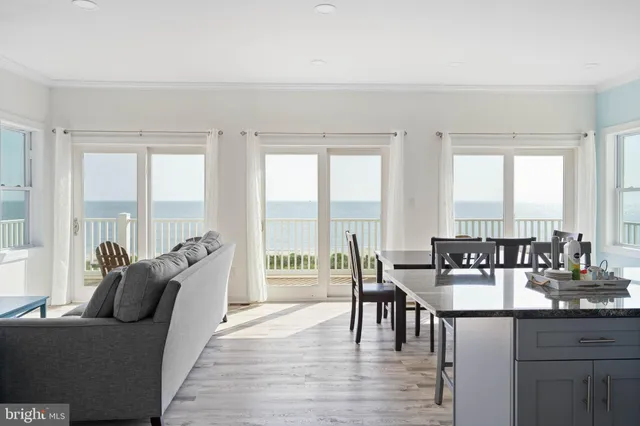 a living room with furniture and floor to ceiling windows