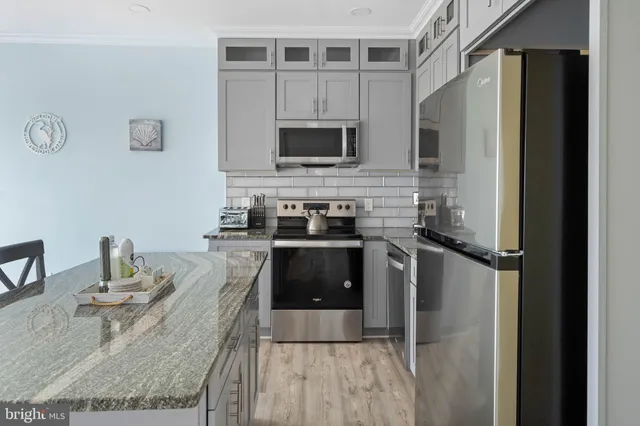 a kitchen with a refrigerator stove and microwave