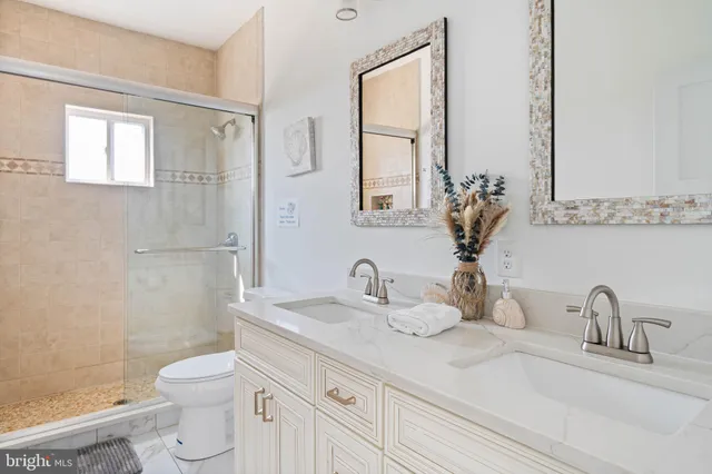 a bathroom with a granite countertop toilet sink and a mirror