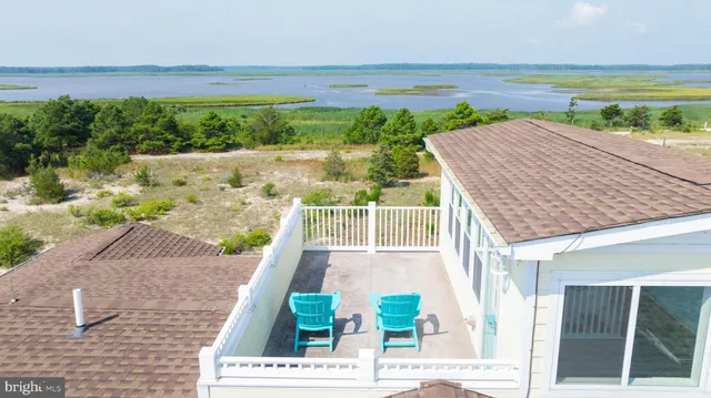 a view of a terrace with wooden floor and a yard