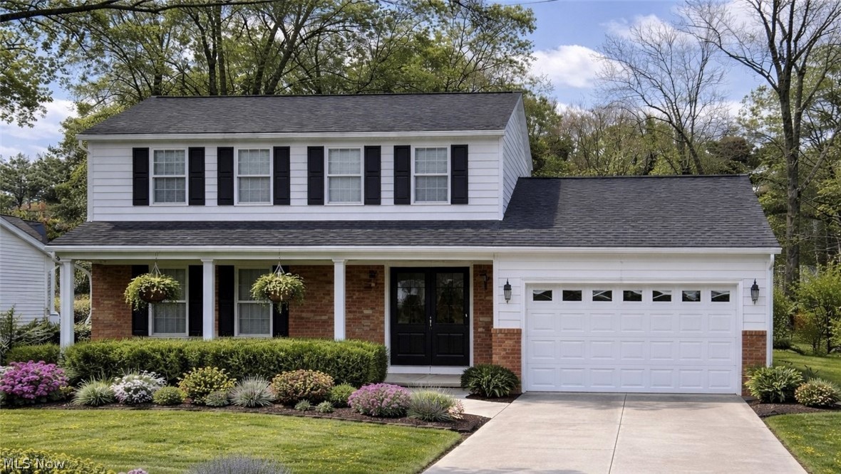 365 Sand Run Road Akron, OH 44313 - Photo 22 of 22 The property features a two-story exterior with white siding and brick accents, a dark shingled roof, and a front porch