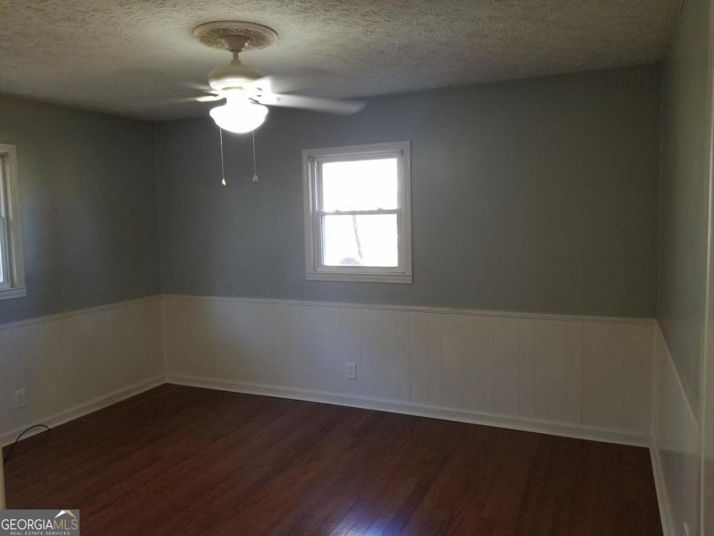 5003 Calhoun Road Northeast Adairsville, GA 30103 - Photo 3 of 11 an empty room with wooden floor and windows