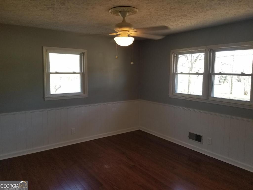 5003 Calhoun Road Northeast Adairsville, GA 30103 - Photo 4 of 11 a view of wooden floor and windows in a room