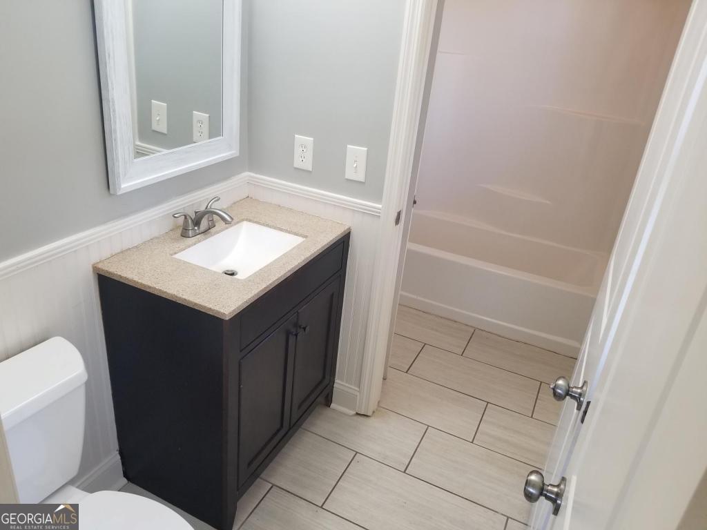 5003 Calhoun Road Northeast Adairsville, GA 30103 - Photo 5 of 11 a bathroom with a sink vanity mirror and toilet
