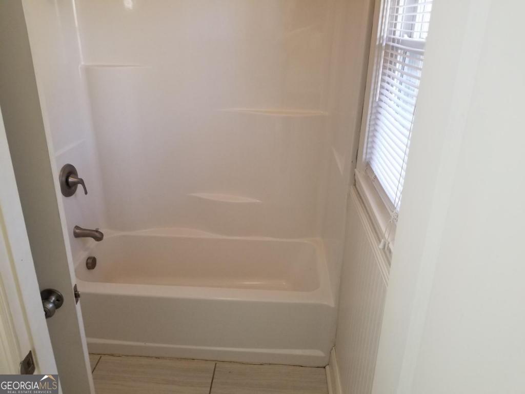 5003 Calhoun Road Northeast Adairsville, GA 30103 - Photo 6 of 11 a close up of a bathtub in shower