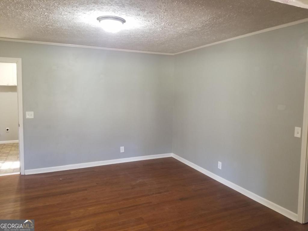 5003 Calhoun Road Northeast Adairsville, GA 30103 - Photo 8 of 11 a view of an empty room with wooden floor