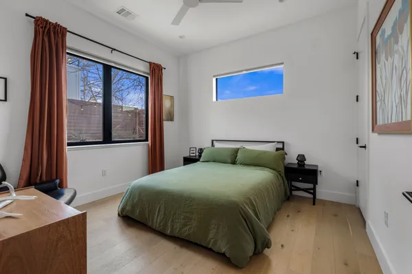 a bedroom with a bed and a window