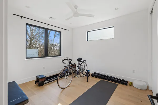 a room with gym equipment and view of bathroom