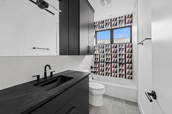 a bathroom with a sink toilet and shower