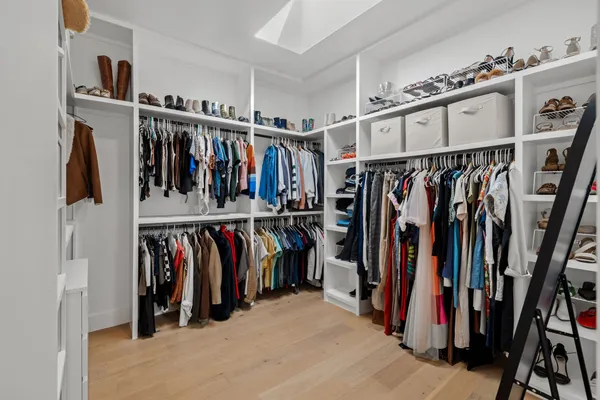 a view of walk in closet with clothes