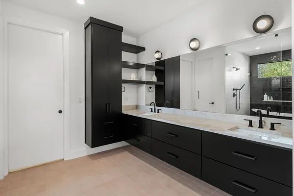 a bathroom with a double vanity sink and mirror
