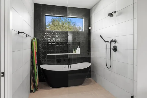 a bathroom with a tub and shower
