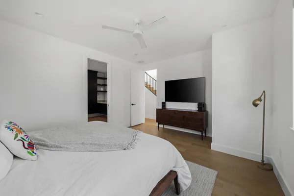 a bedroom with a bed and a flat screen tv