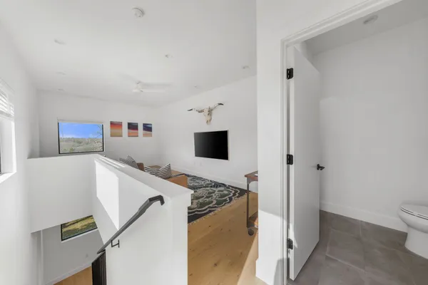 a living room with stainless steel appliances furniture and a kitchen view