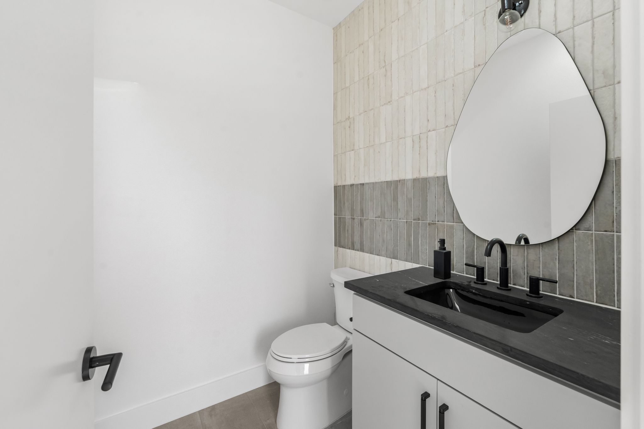 1301 Deloney Street Austin, TX 78721 - Photo 31 of 37 a bathroom with a sink and a mirror