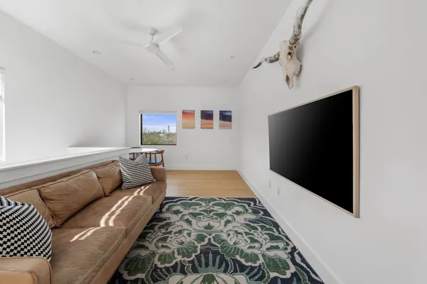 a living room with a flat screen tv and a rug