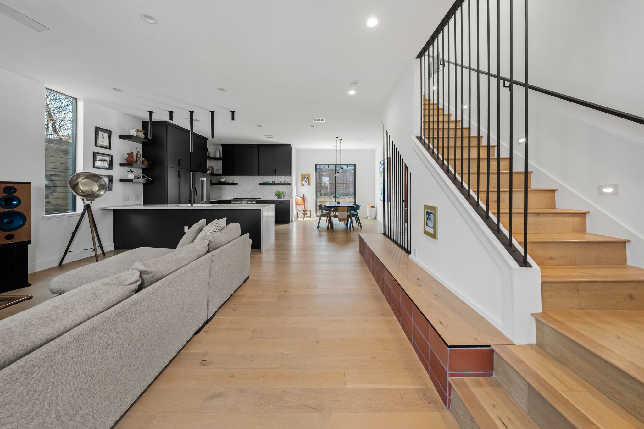 1301 Deloney Street Austin, TX 78721 - Photo 5 of 37 a living room with stainless steel appliances furniture a flat screen tv and a wooden floor