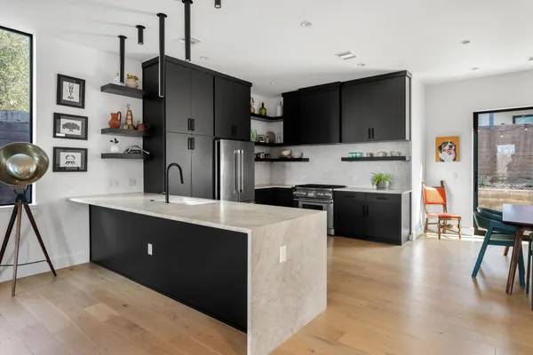 a kitchen with stainless steel appliances a refrigerator stove microwave and sink