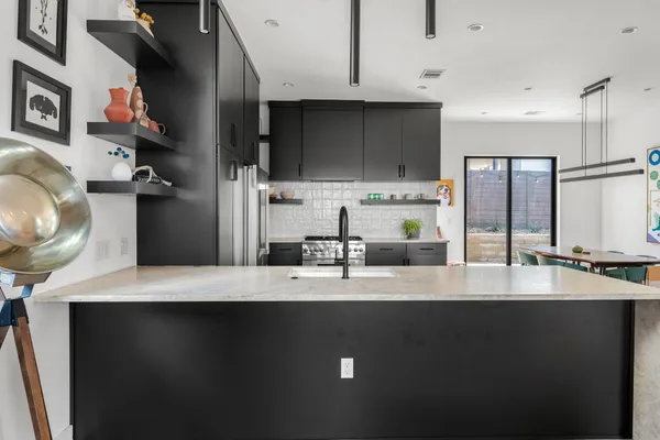 a kitchen with a sink stainless steel appliances and cabinets