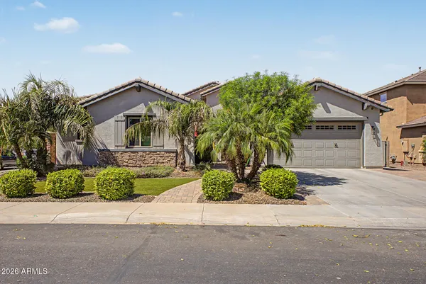a front view of a house with a yard and a garage