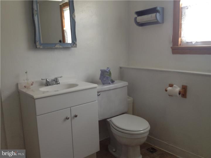 636 Burt Road Runnemede, NJ 08078 - Photo 12 of 18 a bathroom with a toilet sink and mirror