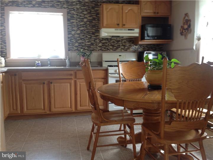 636 Burt Road Runnemede, NJ 08078 - Photo 4 of 18 a view of a kitchen with a table and chairs