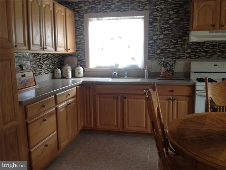 636 Burt Road Runnemede, NJ 08078 - Photo 5 of 18 a kitchen with granite countertop a sink a stove cabinets and wooden floor