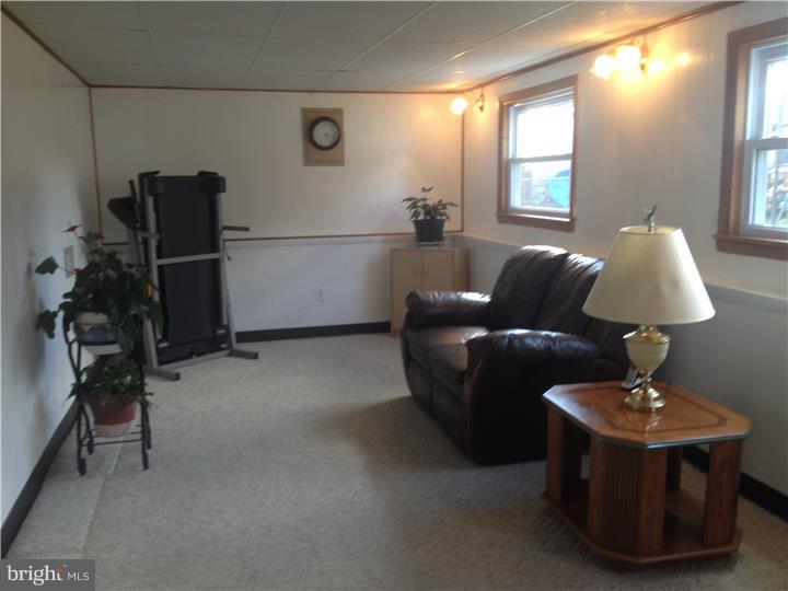 636 Burt Road Runnemede, NJ 08078 - Photo 6 of 18 a living room with furniture a lamp and a window