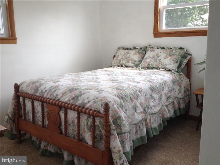 636 Burt Road Runnemede, NJ 08078 - Photo 8 of 18 a bed sitting in a bedroom next to a window