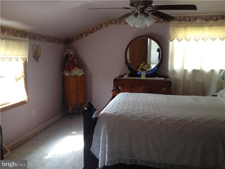 636 Burt Road Runnemede, NJ 08078 - Photo 10 of 18 a bedroom with a bed and a mirror