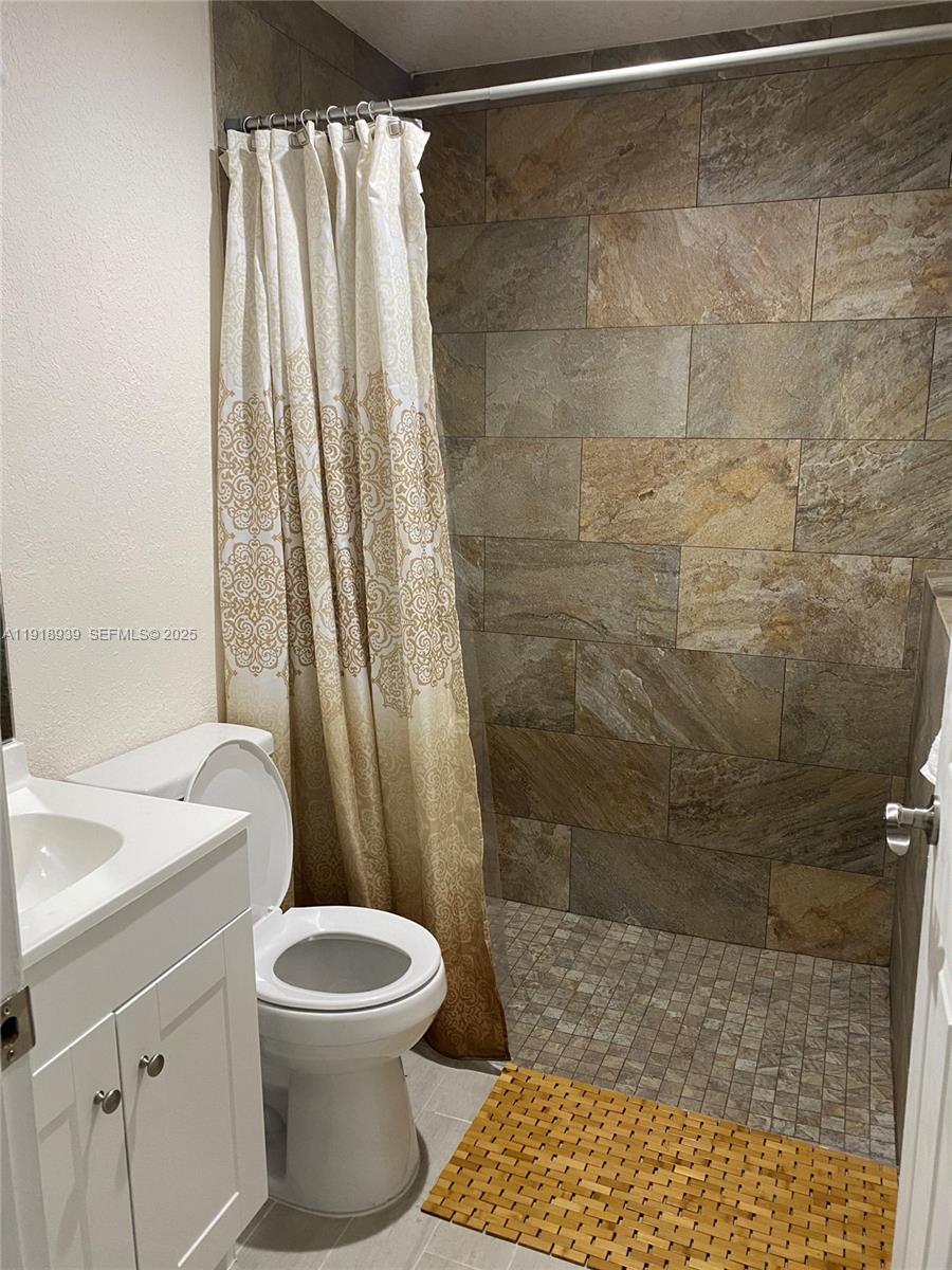 417 Cherry Tree Drive Sebring, FL 33876 - Photo 15 of 26 a bathroom with a sink a toilet and shower