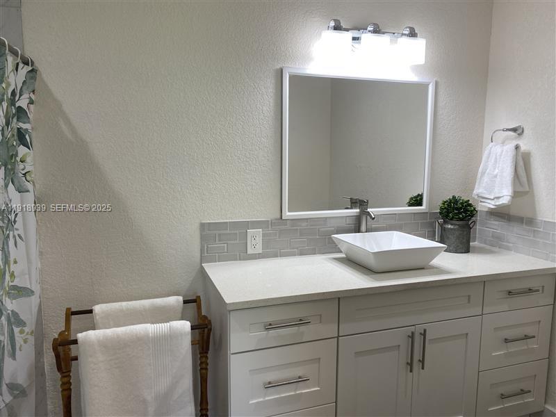 417 Cherry Tree Drive Sebring, FL 33876 - Photo 20 of 26 a bathroom with a granite countertop sink and a mirror