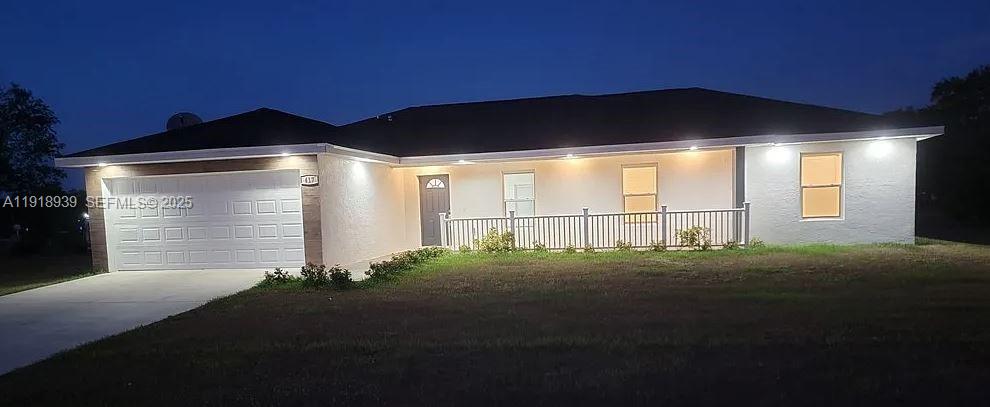 417 Cherry Tree Drive Sebring, FL 33876 - Photo 2 of 26 a front view of a house with a yard