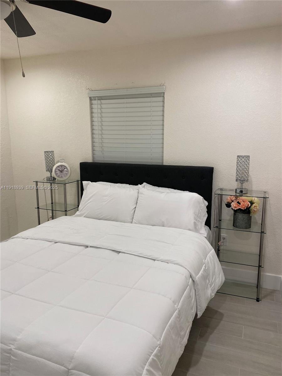 417 Cherry Tree Drive Sebring, FL 33876 - Photo 24 of 26 a large bed sitting in a bedroom next to a window