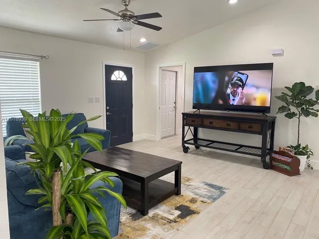 a living room with furniture plant and a potted plant