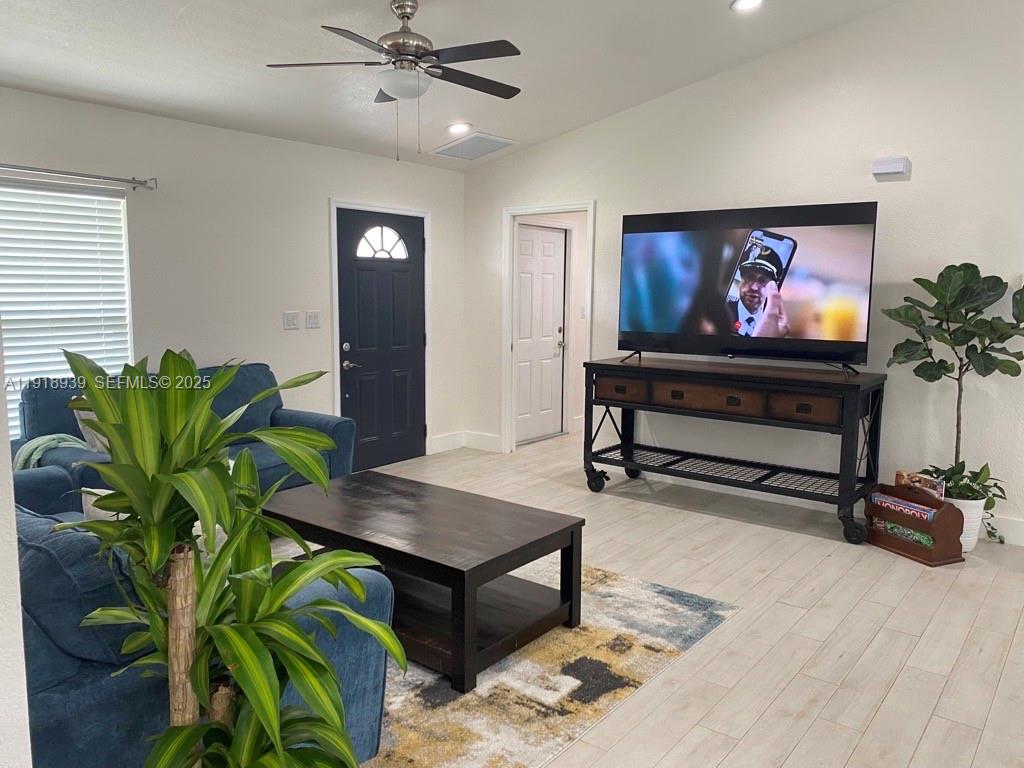 417 Cherry Tree Drive Sebring, FL 33876 - Photo 4 of 26 a living room with furniture plant and a potted plant
