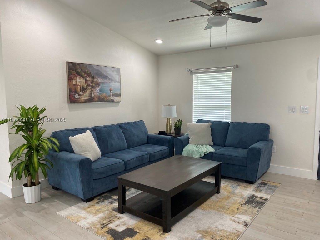 417 Cherry Tree Drive Sebring, FL 33876 - Photo 5 of 26 a living room with furniture and a potted plant